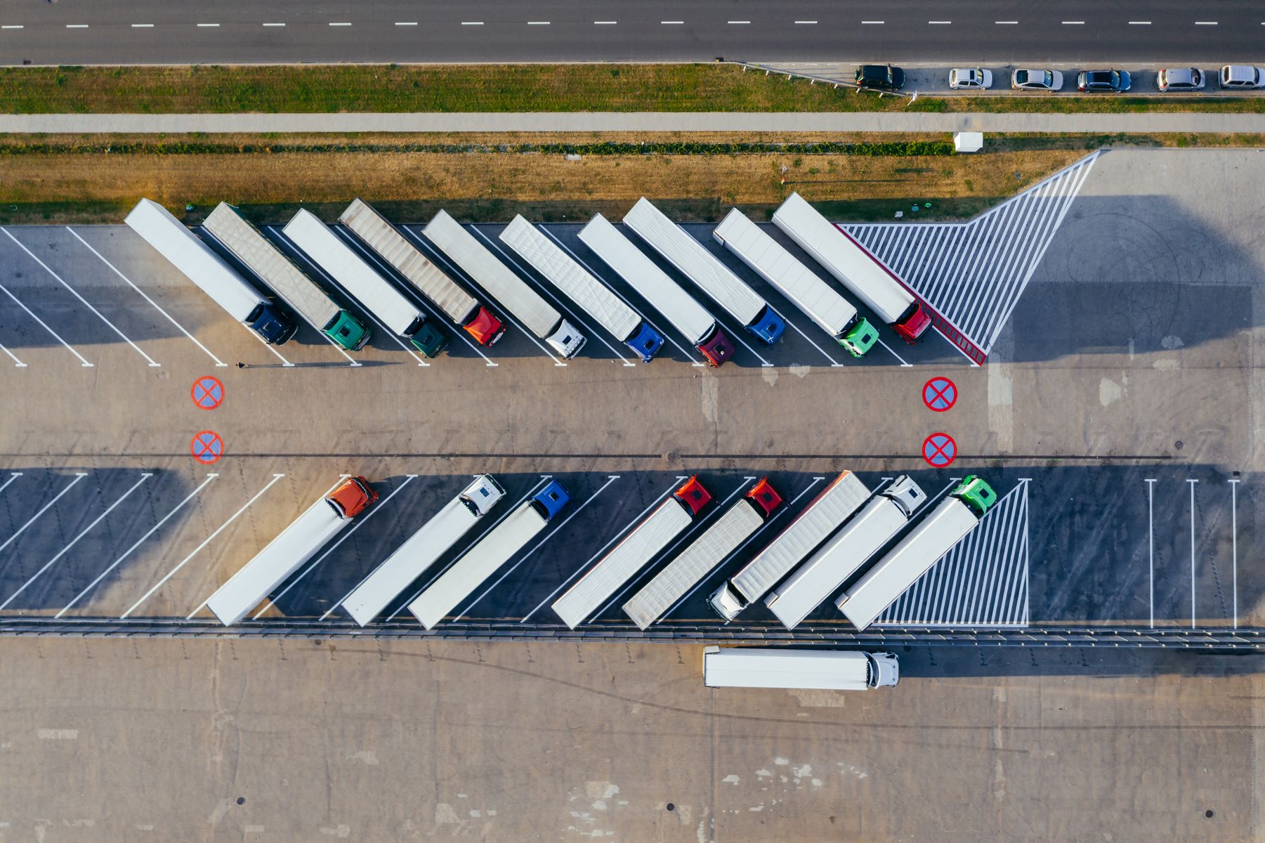 Aerial view of tractor-trailers arranged in a freight yard