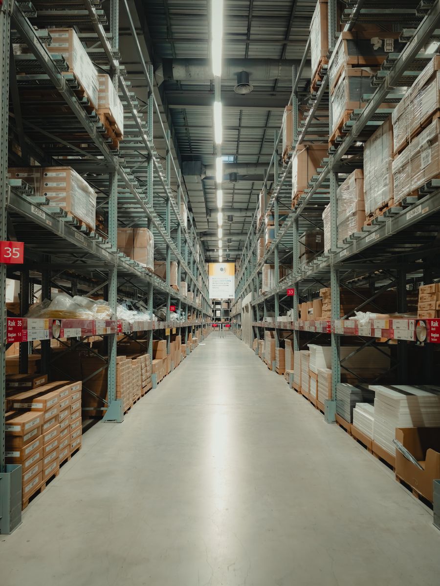 Wide aisle with organized warehouse racks and staged goods